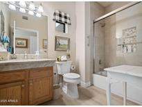 Well-lit bathroom with a shower and tub combo, complemented by a tiled shower and a neutral color palette at 9100 E Raintree Dr # 115, Scottsdale, AZ 85260