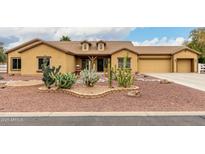 Charming home featuring desert landscaping with cactus and rock accents in the front yard at 9768 W Prospector Dr, Queen Creek, AZ 85144