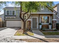 Charming front exterior of a two-story home with stone accents and manicured landscaping at 2315 E Pecan Rd, Phoenix, AZ 85040