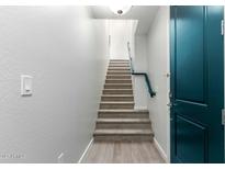Bright entryway with staircase, a blue entry door, leading to the upper level at 2360 E Hidalgo Ave, Phoenix, AZ 85040