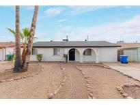 Charming single-story home featuring desert landscaping and an arched entryway at 3217 E Friess Dr, Phoenix, AZ 85032