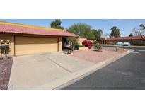 Charming single-story home with a well-maintained yard, attached garage, and vibrant landscaping at 4916 E Hopi St, Phoenix, AZ 85044