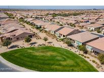 Expansive aerial view of a Primary-planned community with lush green spaces and well-maintained homes in a desirable neighborhood at 825 E Farmers Ln, Queen Creek, AZ 85140