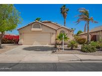 Charming home featuring a two-car garage, desert landscaping, and neutral color palette at 9922 E Onza Ave, Mesa, AZ 85212