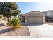 Charming single-story home featuring a well-manicured yard and a two-car garage at 1297 E Maddison St, San Tan Valley, AZ 85140