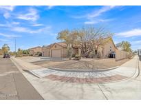 Desert home exterior with a gravel yard, mature landscaping, and a three car garage at 1313 E Tyson St, Chandler, AZ 85225