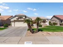 Charming single-story home with a well-manicured lawn and a two-car garage at 14108 W Circle Ridge Dr, Sun City West, AZ 85375