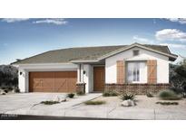 Charming single-story home featuring a two-car garage, brick accents, and desert-friendly landscaping in the front yard at 14777 W Soft Wind Dr, Surprise, AZ 85387