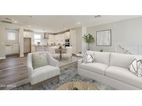 Open concept living space features a modern kitchen, dining area, and hardwood floors with lots of natural light at 2121 W Sonoran Desert Dr # 45, Phoenix, AZ 85085