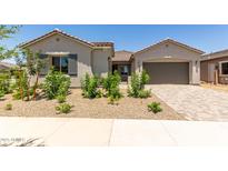 Charming single-story home with desert landscaping and a paver driveway leading to the garage at 21640 E Roundup Way, Queen Creek, AZ 85142