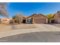 Charming single-story home with a two car garage and low maintenance desert landscaping under a clear blue sky at 4044 E Cascalote Dr, Cave Creek, AZ 85331