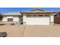 Traditional home featuring an attached two-car garage with a spacious concrete driveway at 7220 W Medlock Dr, Glendale, AZ 85303