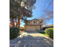 Charming two-story home featuring a well-manicured lawn and an attached two-car garage at 1043 W Washington Ave, Gilbert, AZ 85233