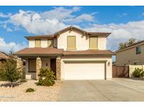 Two story home featuring a front yard, neutral color scheme, and a two-car garage at 11128 E Segura Ave, Mesa, AZ 85212