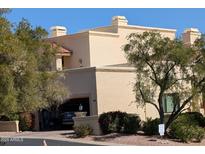 Charming tan stucco home featuring a tile roof, garage, and well-maintained landscaping at 16724 E Gunsight Dr # 121, Fountain Hills, AZ 85268