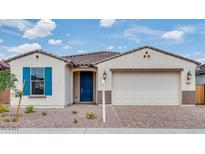 Charming single-story home showcasing a tidy front yard, blue door, and a two-car garage at 16778 W Yucatan Dr, Surprise, AZ 85378