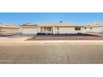 Charming single-story home with a two-car garage, desert landscaping, and well-maintained exterior in a peaceful neighborhood at 18002 N 135Th Dr, Sun City West, AZ 85375