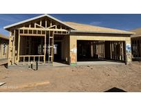 Framing of new home with unfinished garage and entry showing layout and design against a blue sky at 2076 E Bucking Bronco Dr, San Tan Valley, AZ 85140