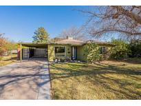 Charming single-story home featuring a spacious front yard and covered carport at 3027 N 21St Pl, Phoenix, AZ 85016