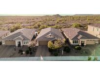 A panoramic view of three single-story homes in a desert community, showcasing their tile roofs at 30816 N 138Th Ave, Peoria, AZ 85383