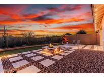 An outdoor fire pit area with desert views and modern landscaping, perfect for entertaining at 30816 N 138Th Ave, Peoria, AZ 85383