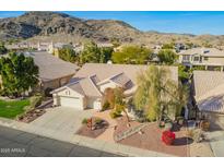 Stunning aerial view of a single-Gathering home with a three car garage, mature landscaping and mountain views at 3144 E Desert Broom Way, Phoenix, AZ 85048