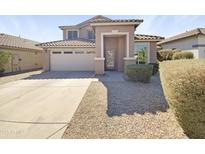 Charming two-story home with a well-manicured yard, a garage, and a decorative security door at 3201 W Five Mile Peak Dr, San Tan Valley, AZ 85144