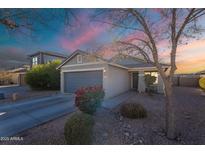 Charming single-story home featuring a well-maintained front yard and attached two-car garage at 34734 N Happy Jack Dr, San Tan Valley, AZ 85144