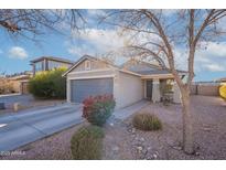 Charming single-story home featuring a gray garage door, neutral exterior paint, and low-maintenance desert landscaping at 34734 N Happy Jack Dr, San Tan Valley, AZ 85144