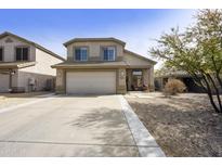 Charming two-story home featuring a spacious driveway and low-maintenance desert landscaping at 4439 E Coyote Wash Dr, Cave Creek, AZ 85331