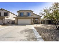 Charming two-story home with a well-maintained front yard, a two-car garage, and a cozy front porch at 4439 E Coyote Wash Dr, Cave Creek, AZ 85331
