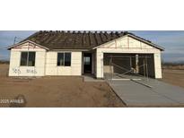 New home under construction showing the framing, windows, garage and new driveway at 5893 N Nigal Rd, Casa Grande, AZ 85194