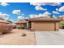 Charming single-story home featuring a desert landscape and a two-car garage at 7214 W Crest Ln, Glendale, AZ 85310