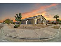 Charming single-story home featuring desert landscaping, warm exterior paint, and a three-car garage at 906 E Beautiful Ln, Phoenix, AZ 85042