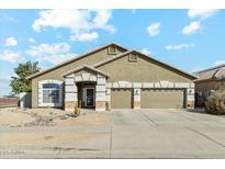 Charming single-story home featuring a three-car garage and low-maintenance desert landscaping at 906 E Beautiful Ln, Phoenix, AZ 85042