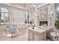 A sunlit office features a fireplace, decorative mirror, custom cabinetry, and coordinated decor for a refined atmosphere at 9547 N 55Th St, Paradise Valley, AZ 85253