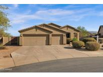 Charming single-story home featuring a three-car garage, desert landscaping, and a tile roof at 13121 S 178Th Ave, Goodyear, AZ 85338