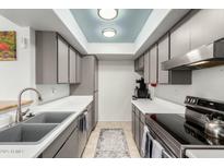 Well-lit kitchen with stainless steel appliances and skylight for a modern feel at 13204 N 3Rd Way, Phoenix, AZ 85022