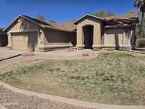 Charming single-story home featuring a landscaped front yard and an attached two-car garage at 1688 E Krystal St, Casa Grande, AZ 85122