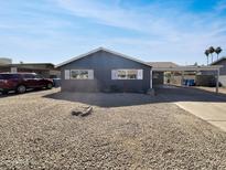 Charming single-story home features desert landscaping, covered parking, and white window shutters at 3009 W Laurel Ln, Phoenix, AZ 85029