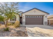 Beautiful single-story home with a two-car garage and desert landscaping at 35621 W San Alvarez Ave, Maricopa, AZ 85138