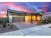 Charming single-Gathering home featuring a well-maintained front yard and a cozy covered porch with stone pillars at 4330 S Neutron --, Mesa, AZ 85212
