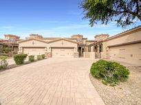 A beautiful home featuring a private driveway, garages, and desert landscaping at 6202 E Mckellips Rd # 227, Mesa, AZ 85215