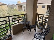 The patio has a decorative table, chairs, and potted plants creating a relaxing outdoor space at 7887 N 16Th St # 227, Phoenix, AZ 85020