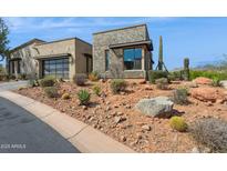 Stunning desert home with rock landscaping, stone accents and a spacious two-car garage at 15921 E Ridgestone Dr, Fountain Hills, AZ 85268