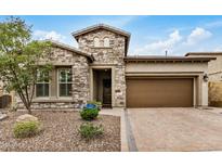 Charming stone-clad home featuring a paver driveway and well-maintained, drought-resistant landscaping at 1752 N Harper --, Mesa, AZ 85207