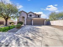 Charming two-story home with a three car garage and well-manicured front yard at 2014 S Archer Cir, Mesa, AZ 85209