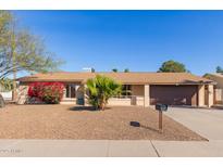 Charming single-story home with desert landscaping, tan brick accents, and a well-maintained lawn at 3238 E Cholla St, Phoenix, AZ 85028