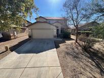 Charming two-story home with a well-maintained front yard, spacious driveway, and attached two-car garage at 4669 E Sierrita Rd, San Tan Valley, AZ 85143