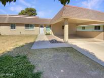 Inviting single-story home featuring a covered carport, low maintenance landscaping, and a welcoming front entrance at 9814 N Balboa Dr, Sun City, AZ 85351